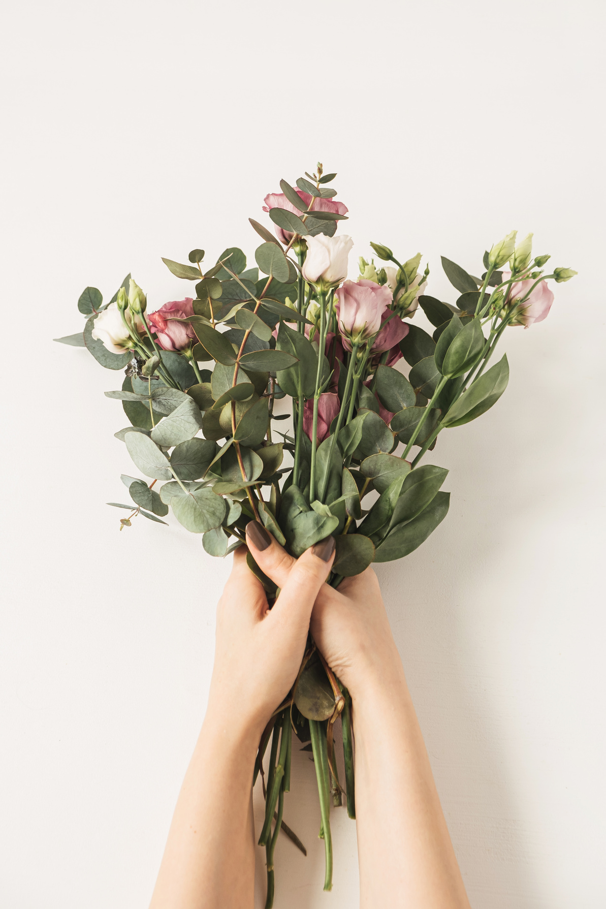 Hands holding a bouquet of flowers